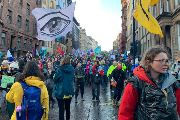 COP26 Protestors filling the streets holding flags